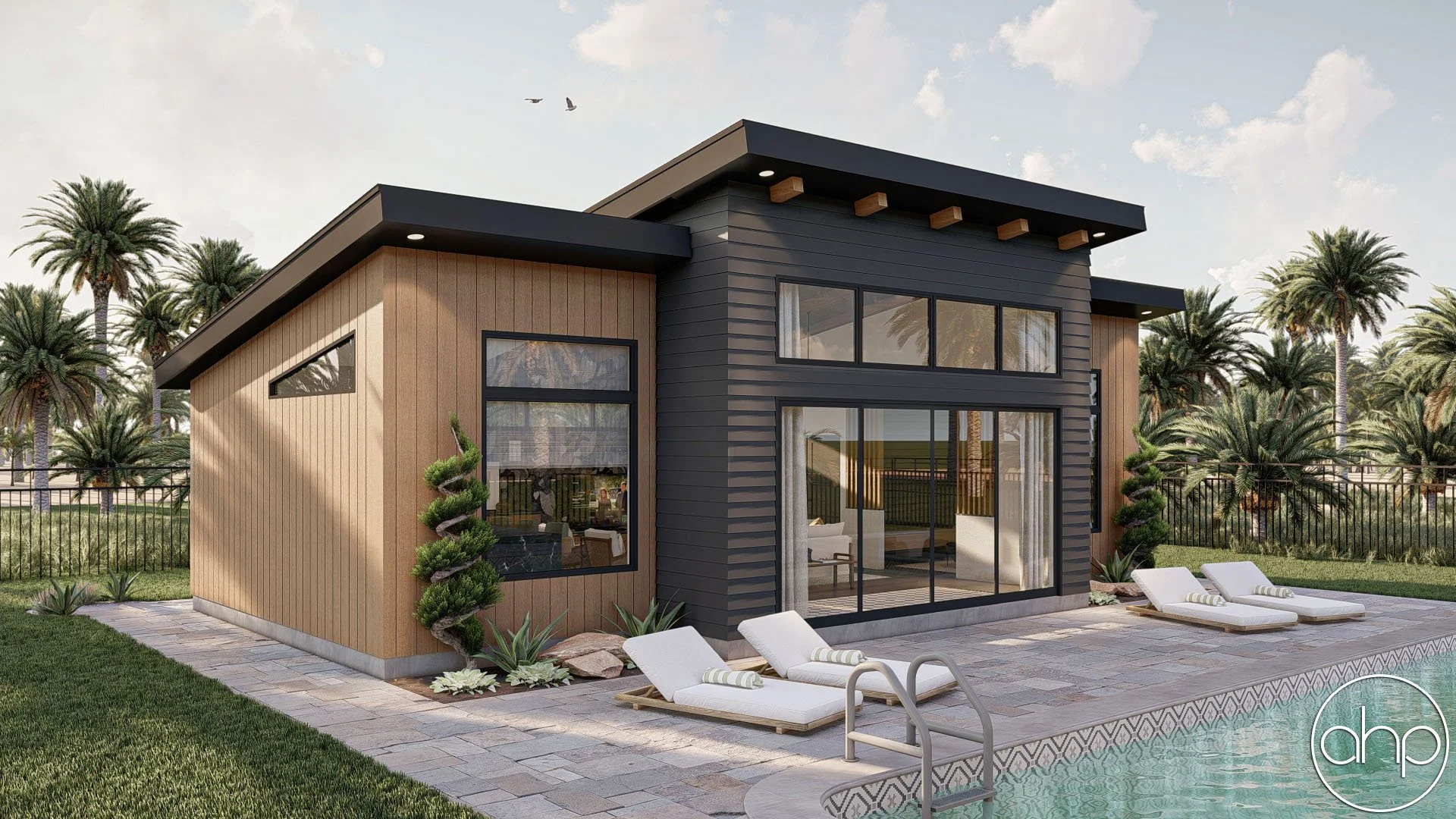 Modern house with wood and black siding exterior next to a swimming pool with lounge chairs, surrounded by palm trees and a fenced yard under a partly cloudy sky.