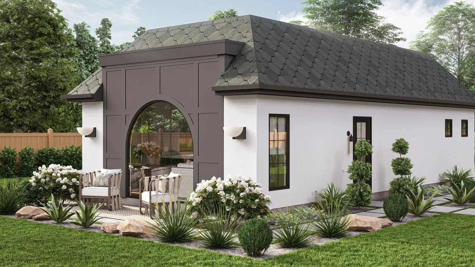 Modern backyard of a white house with gray accents, featuring a landscaped garden with green grass, small bushes, and rocks, and outdoor furniture beside a large arched window.