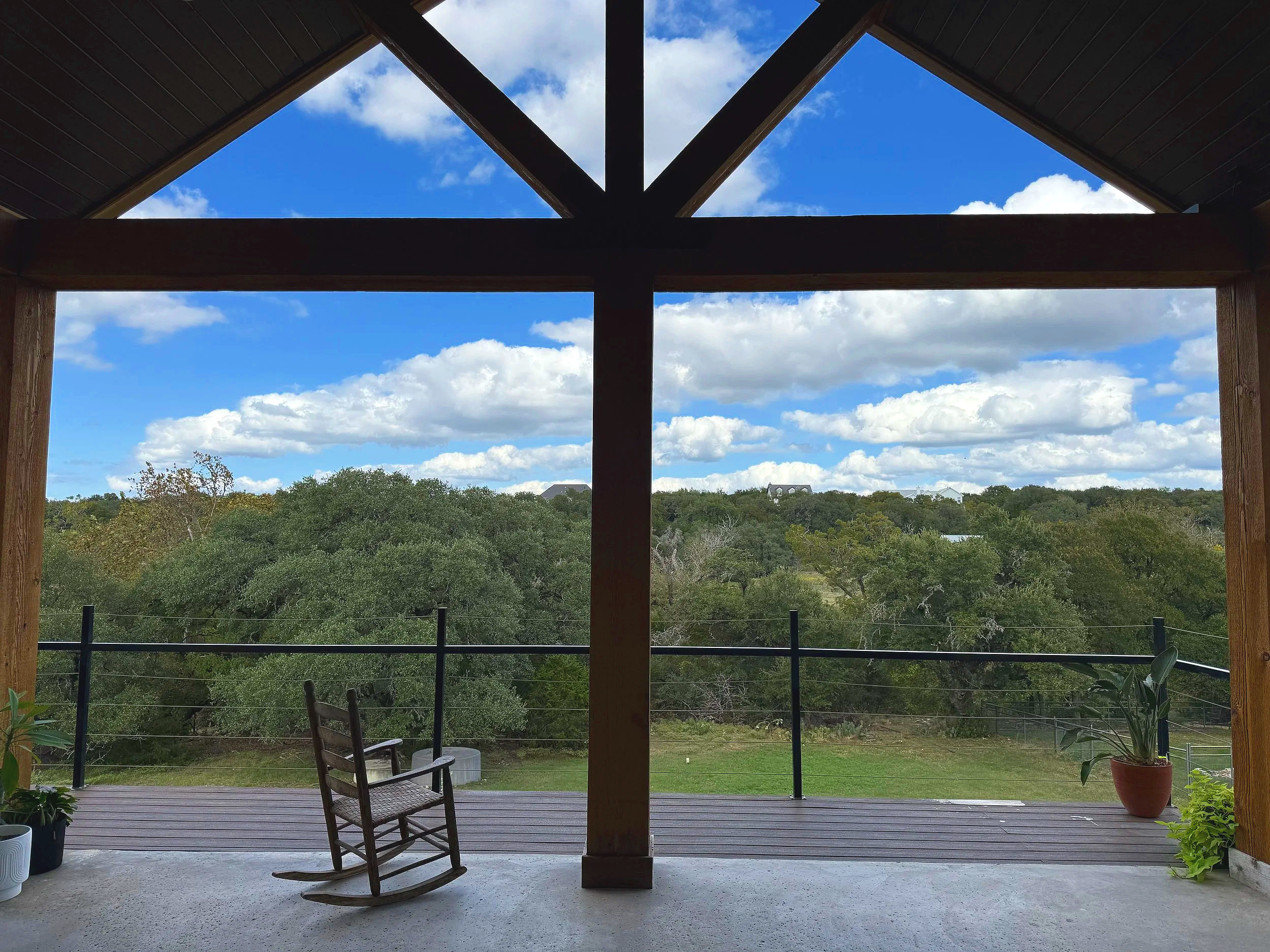 Covered outdoor living space overlooking the Hill Country from an elevated homesite
