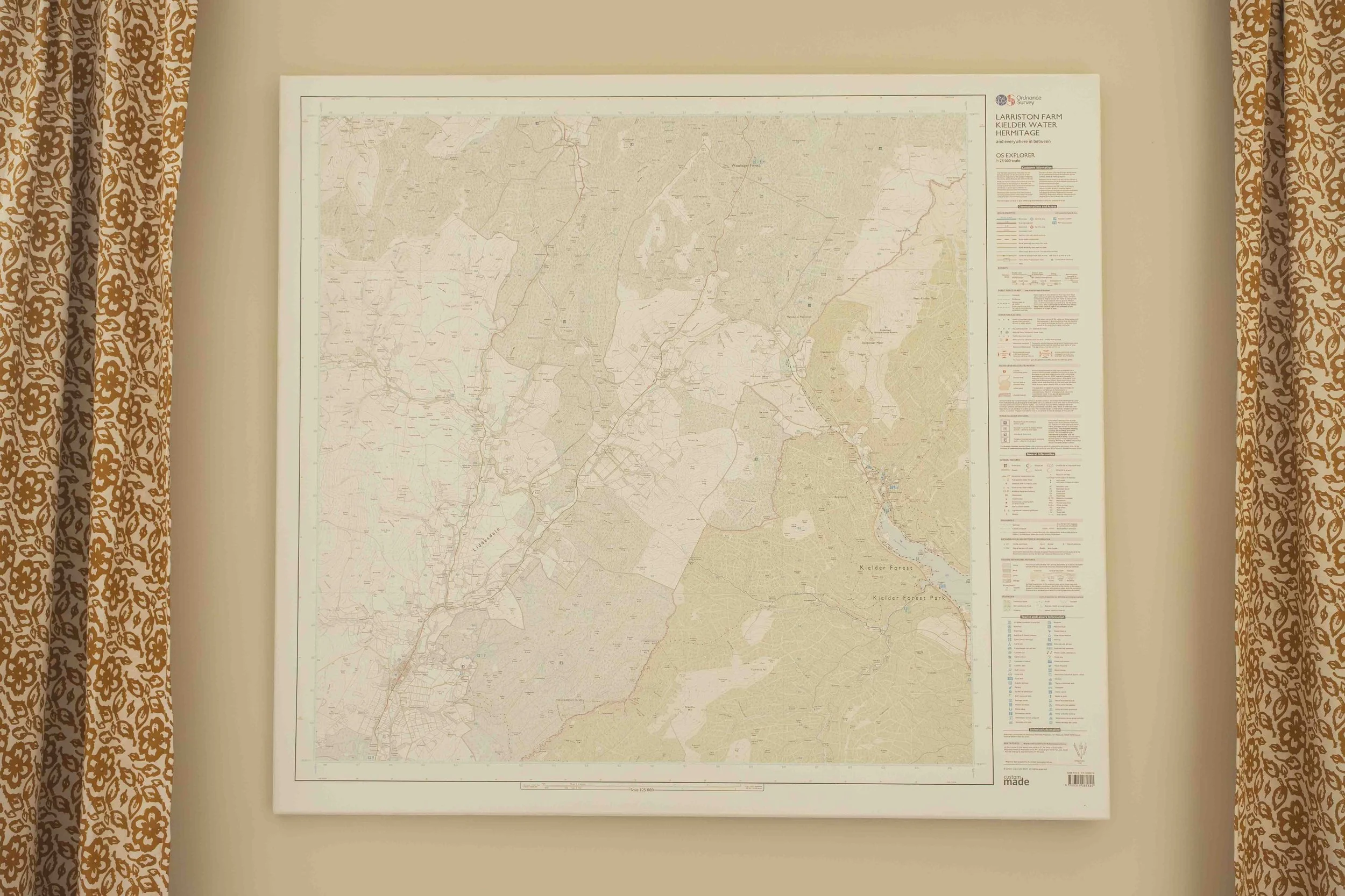 A large detailed map on a wall showing the area around Kleider Forest, with beige patterned curtains on both sides.