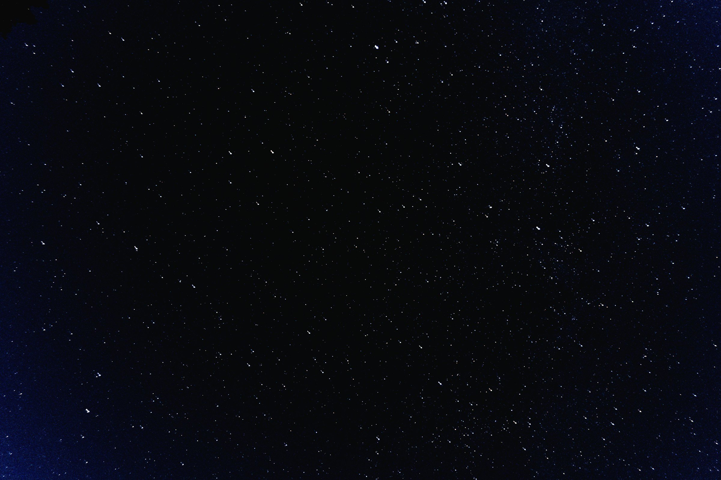 A starry night sky with numerous stars visible across the dark background.