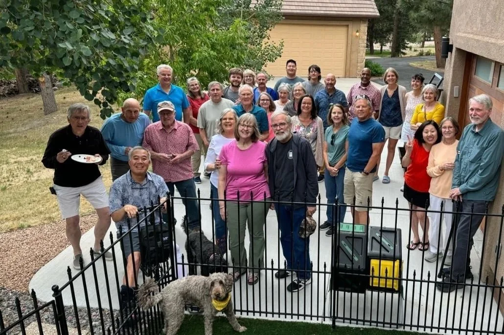 A Forestgate Community Group smiles on a patio