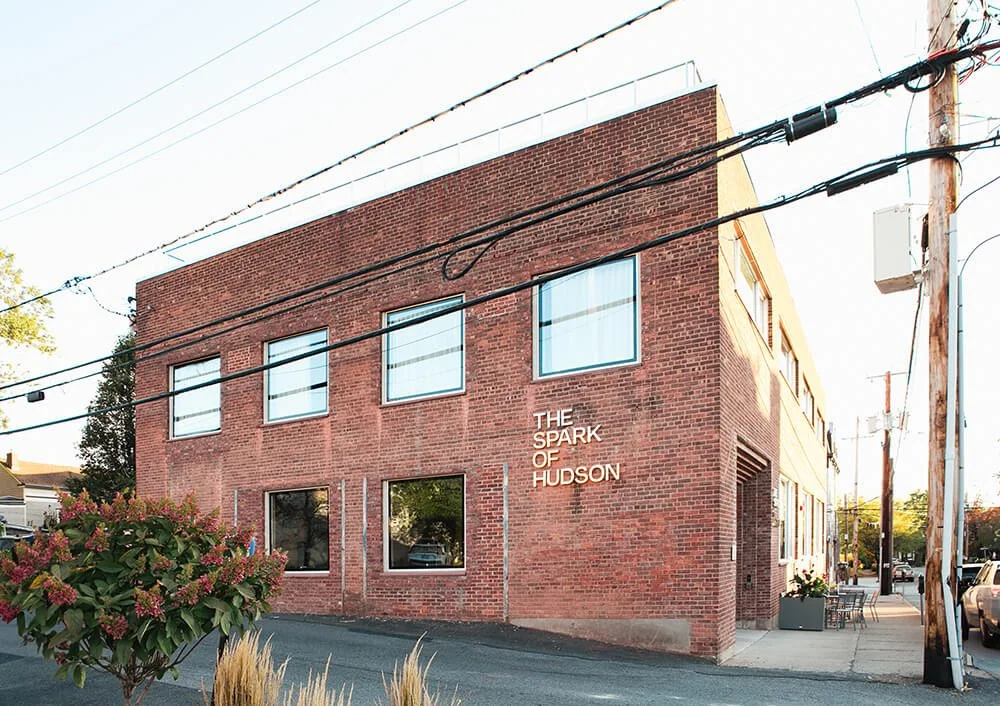 The Spark of Hudson, a 3 story brick building with windows