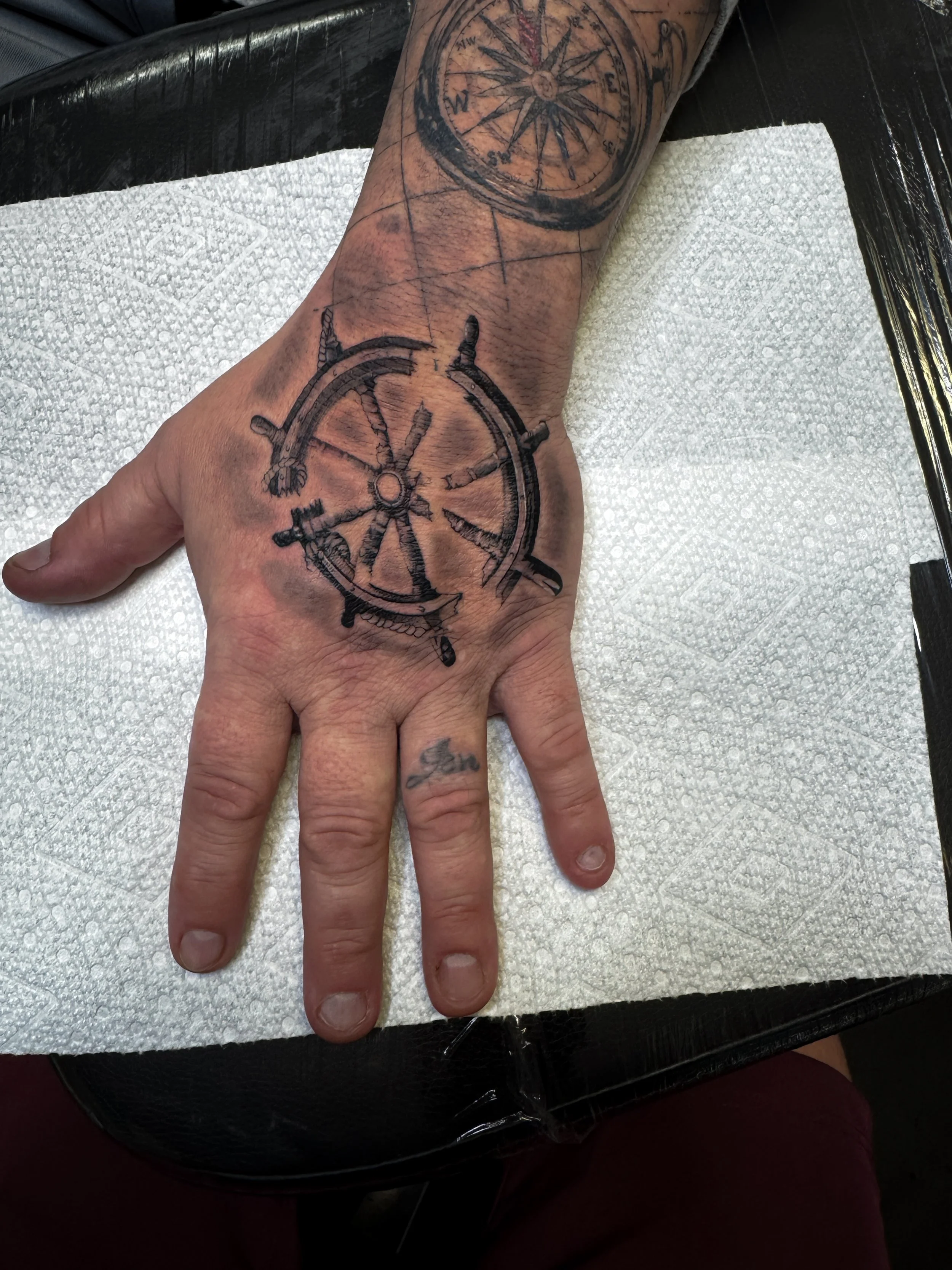 ship wheel tattoo hand tattoo realism tattoo black and grey realism tattoo letterring tattoo, fine line tattoo, in Stuart, Sewall’s Point, Hutchinson Island, Jensen Beach, Palm City, Port St. Lucie, Fort pierce, treasure coast and surrounding South F