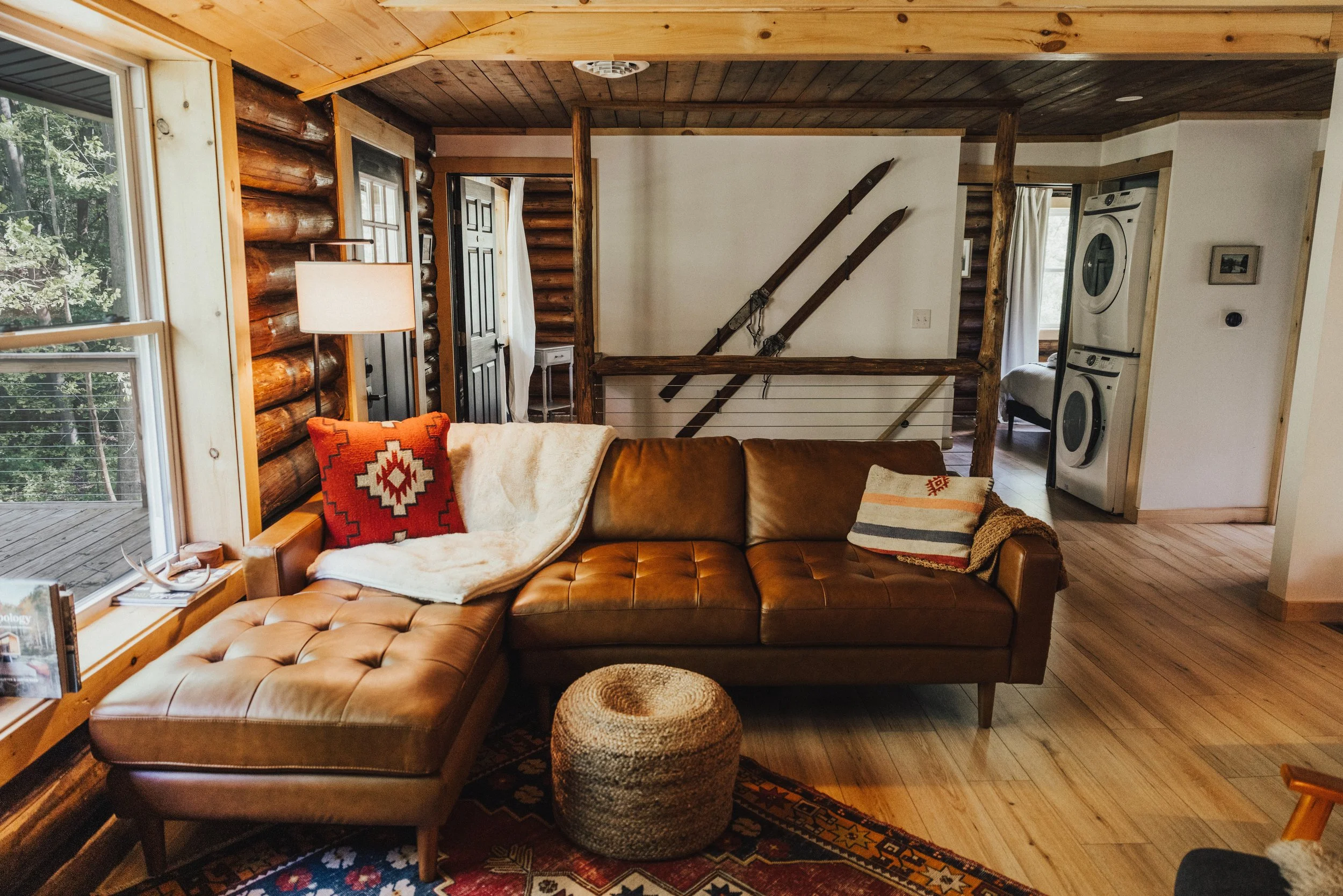 LIVING ROOM ~ Upstairs Living Room Enjoy a warm gas stove, comfortable seating, and a beautiful view of the wooded hill