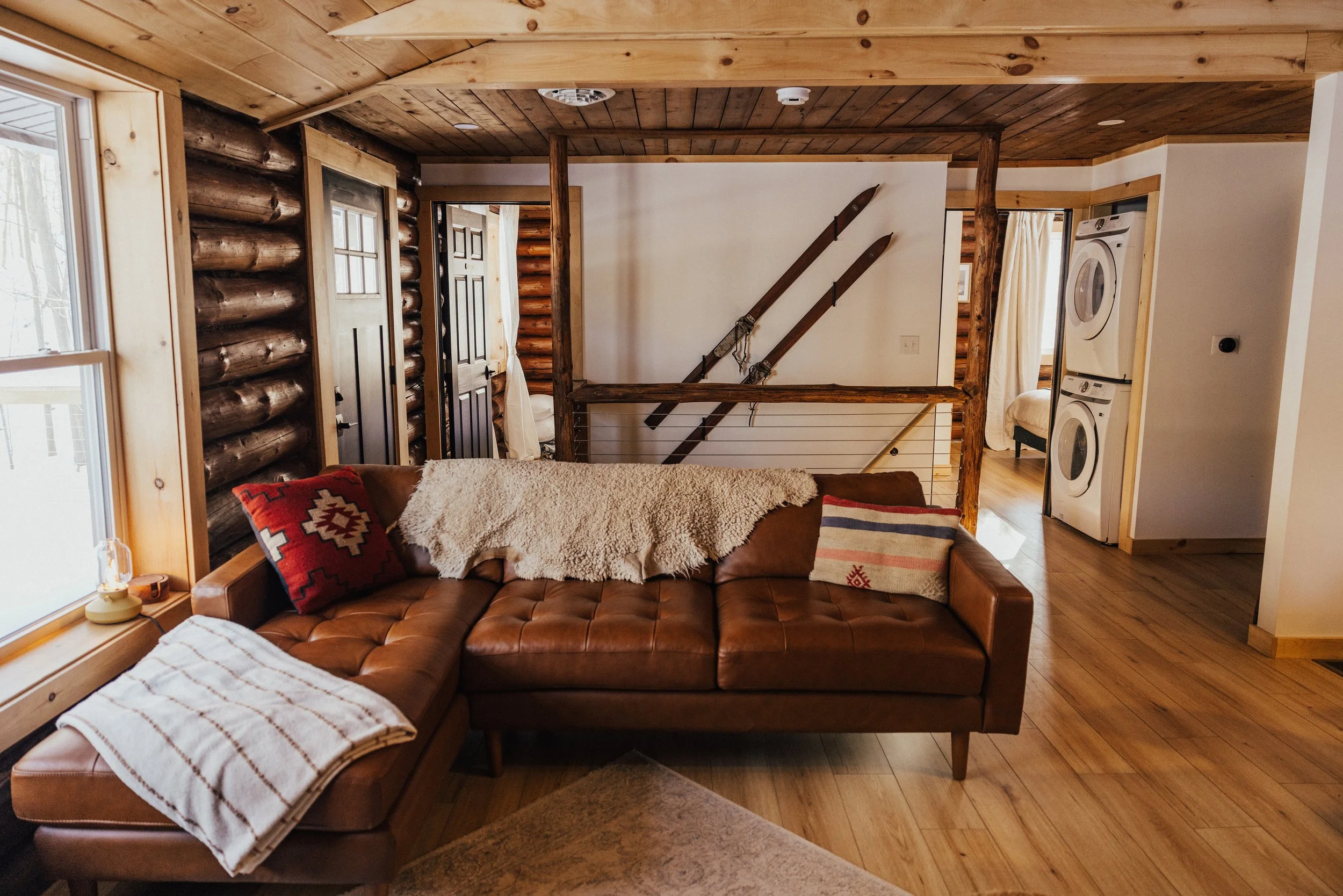 LIVING ROOM ~ Upstairs Living Room Enjoy a warm gas stove, comfortable seating, and a beautiful view of the wooded hill