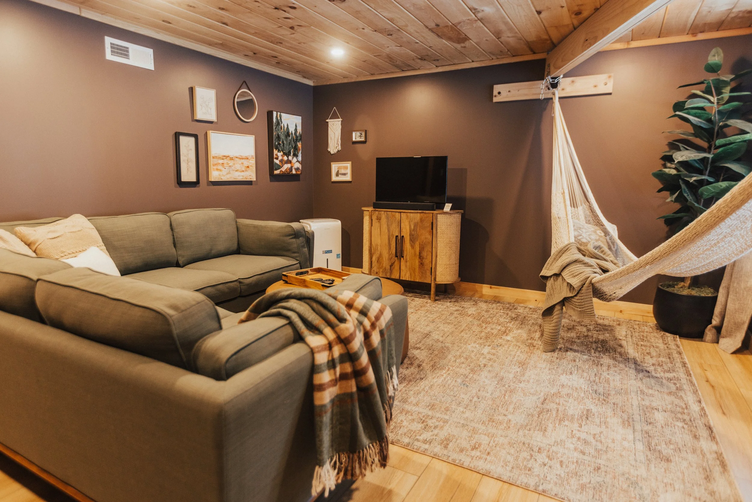 DOWNSTAIRS LIVING ROOM ~
Relax on the Article sofa and stream your shows on the Amazon Fire TV, or swing in the hammock with a good book