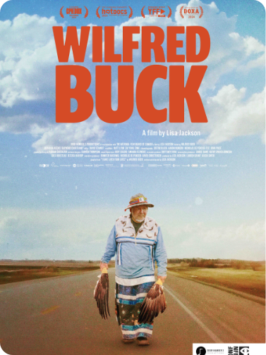 Movie poster for 'Wilfred Buck' featuring a man walking on an empty road in a rural landscape, wearing a hat and holding objects in each hand, with a bright blue sky with clouds above.