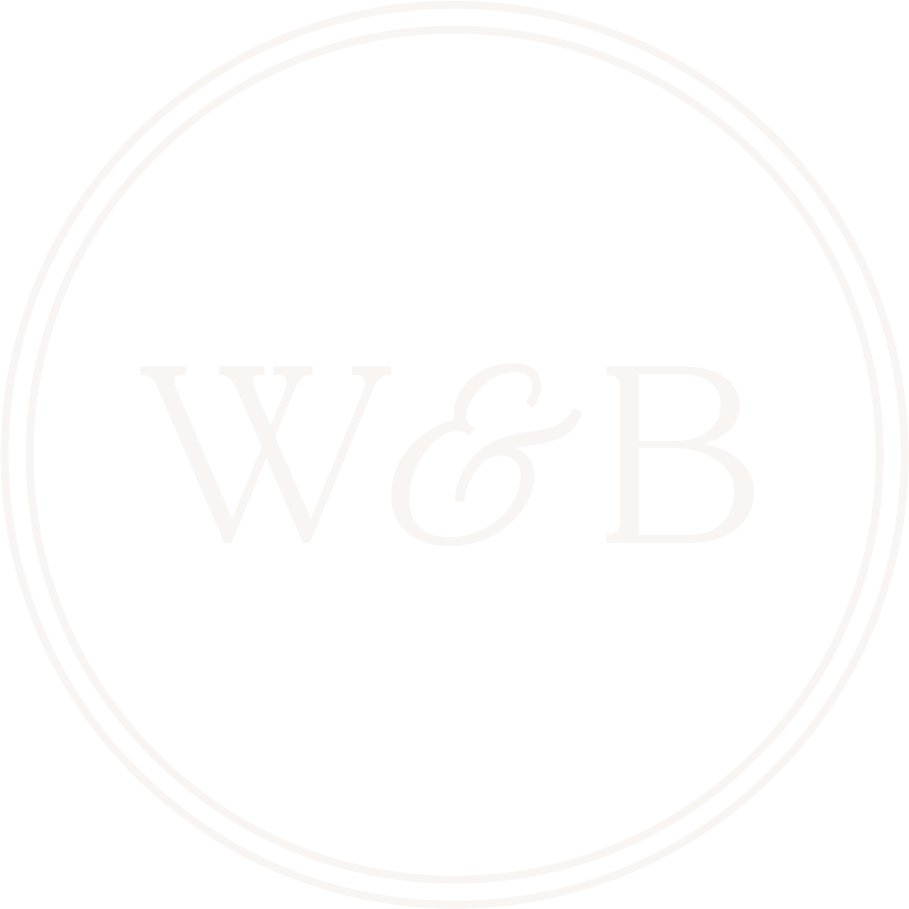 Black circular logo with white double outlines and the letters W and B separated by an ampersand in the center.
