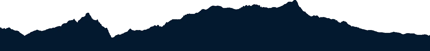 A mountain landscape with snow-covered peaks and a dark sky.