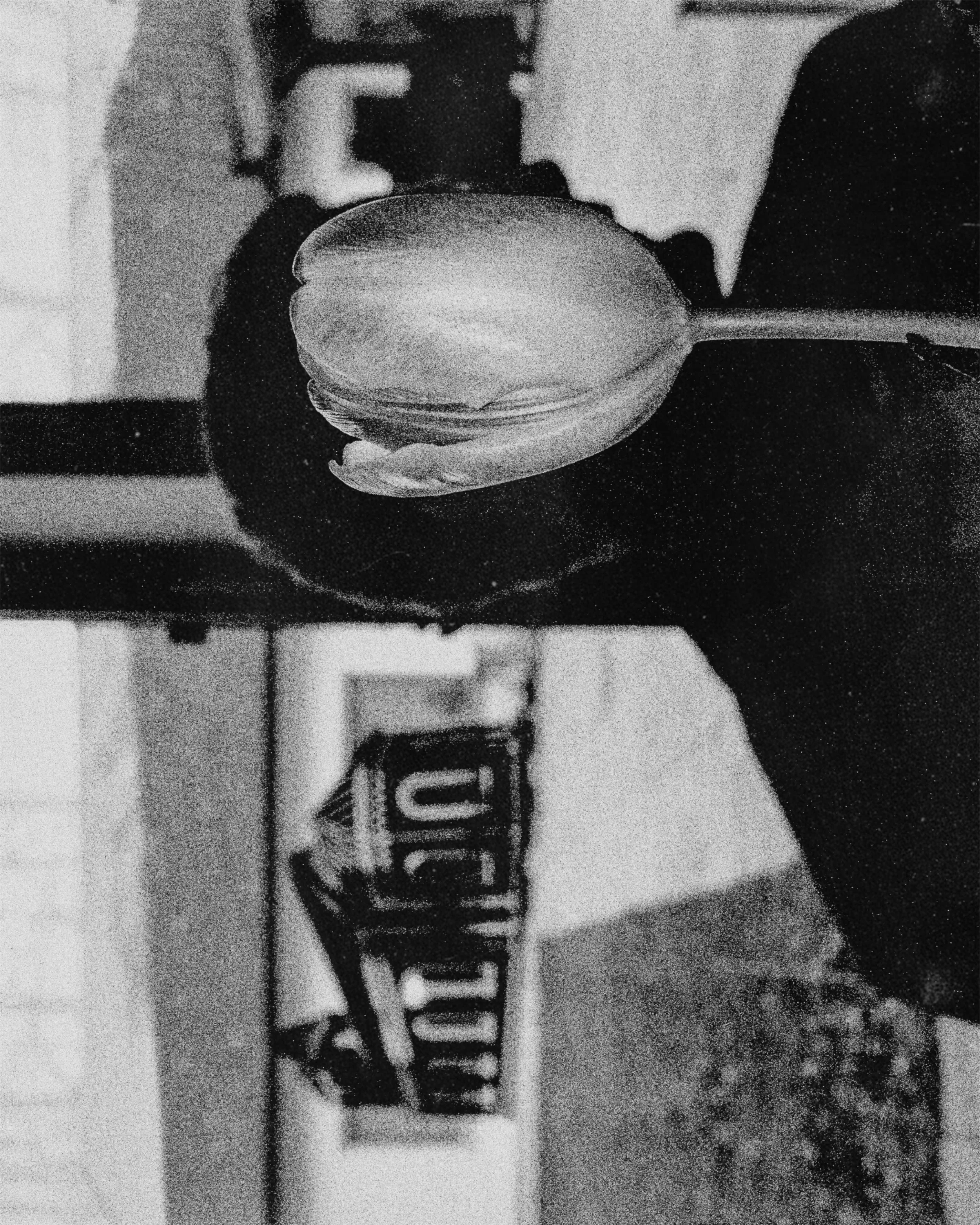 A person holding a small container with a spoon inside.
