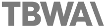 The image displays the text 'TBWA' in bold, white letters on a dark background.