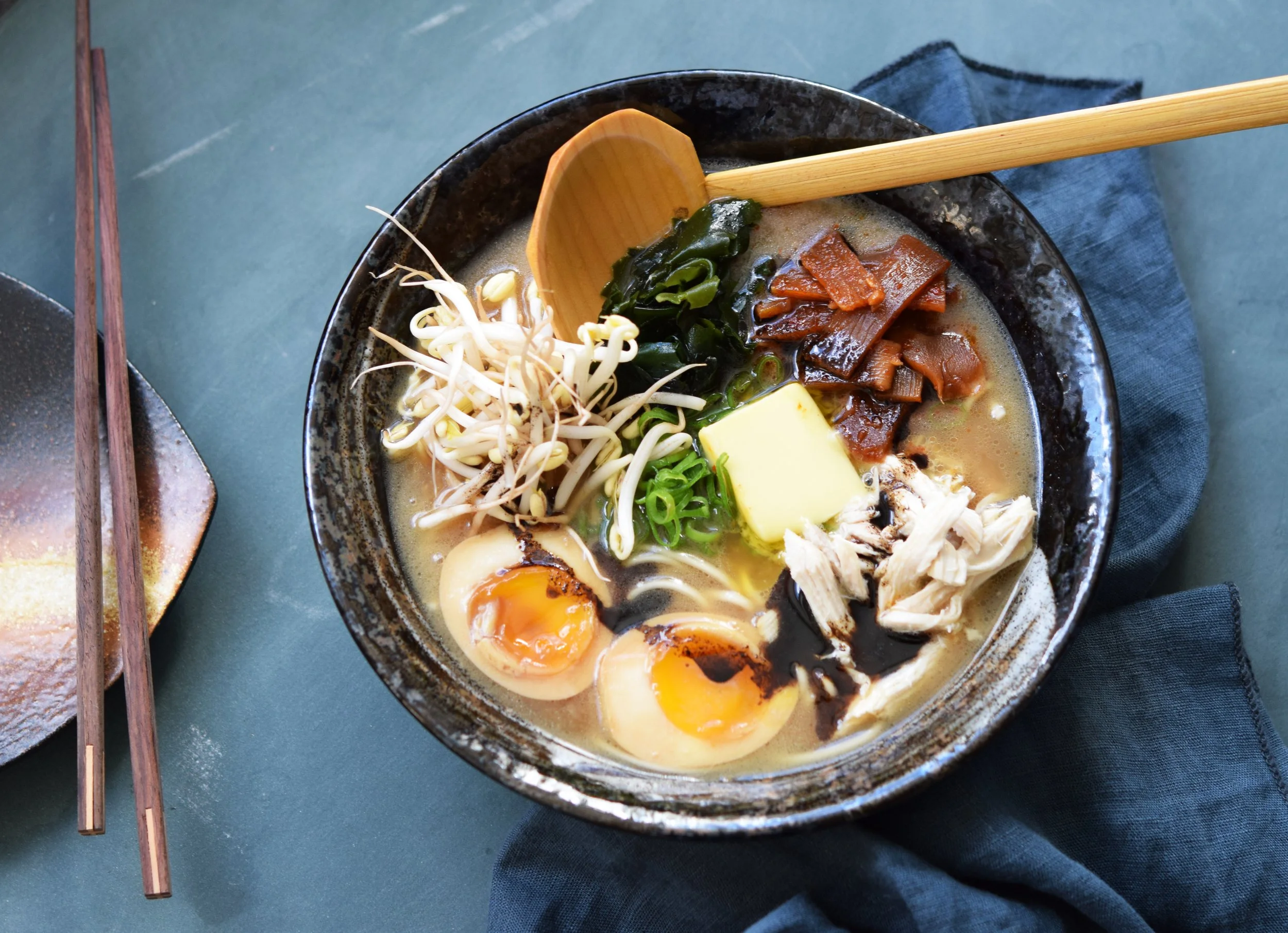 Japanese shoyu ramen with noodles, chashu chicken, ajitama egg and an umami rich broth, served in a traditional ramen bowl.