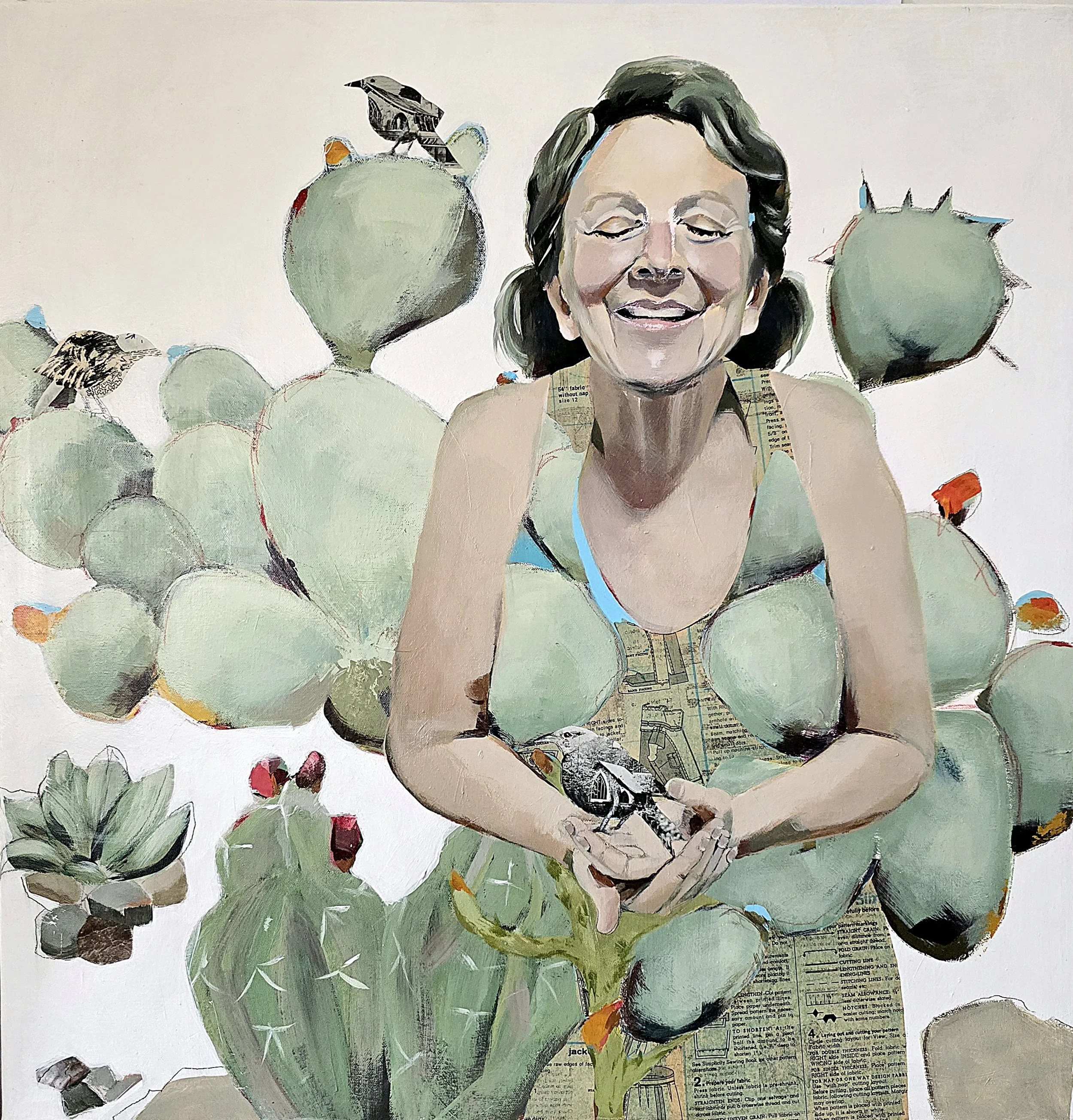 A collage-style artwork of a woman with a smiling face, surrounded by cacti and birds, created using painted and printed paper elements.