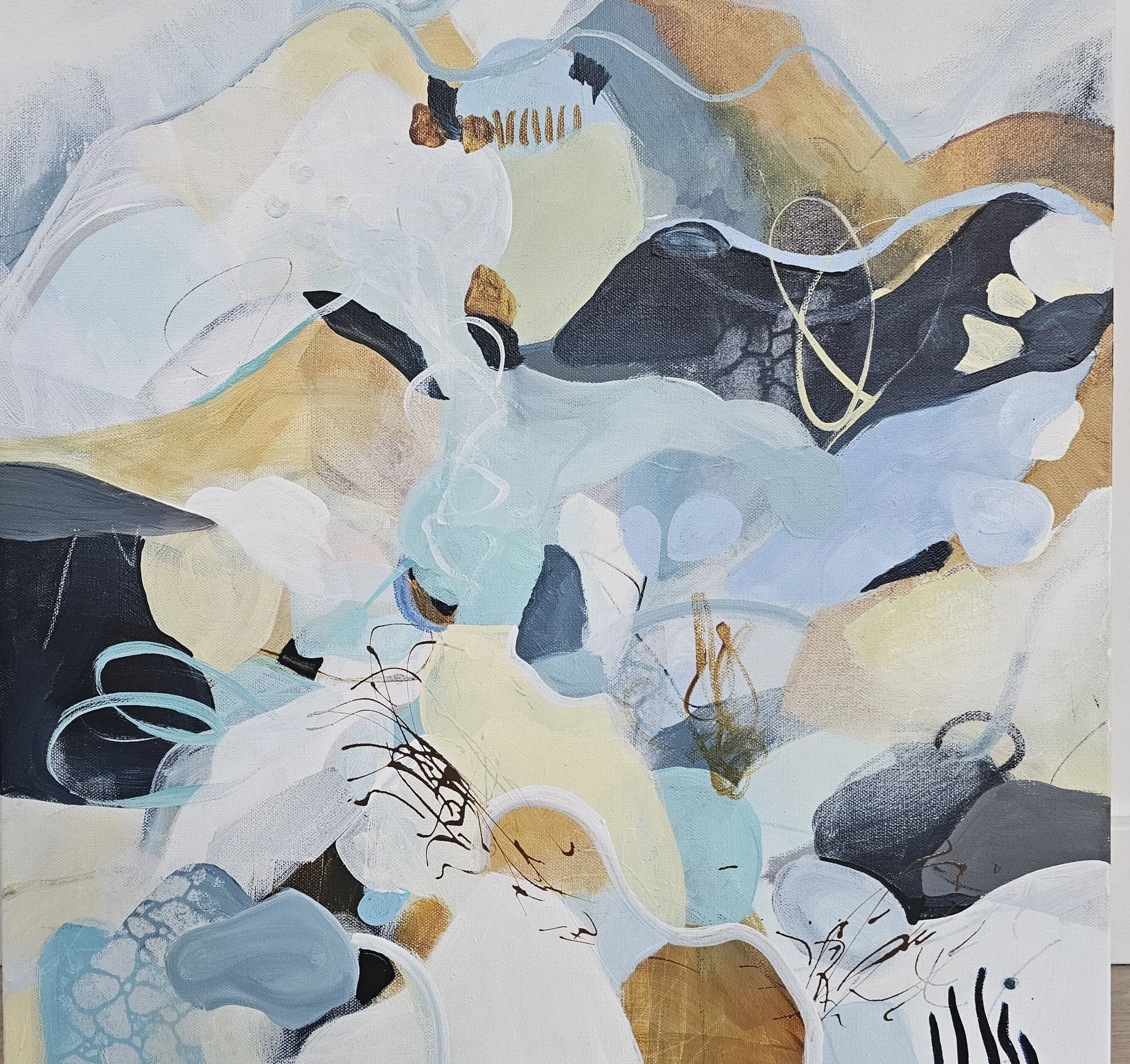 Abstract painting with swirling shapes and colors including blue, white, black, and beige with hints of gold and brown.
