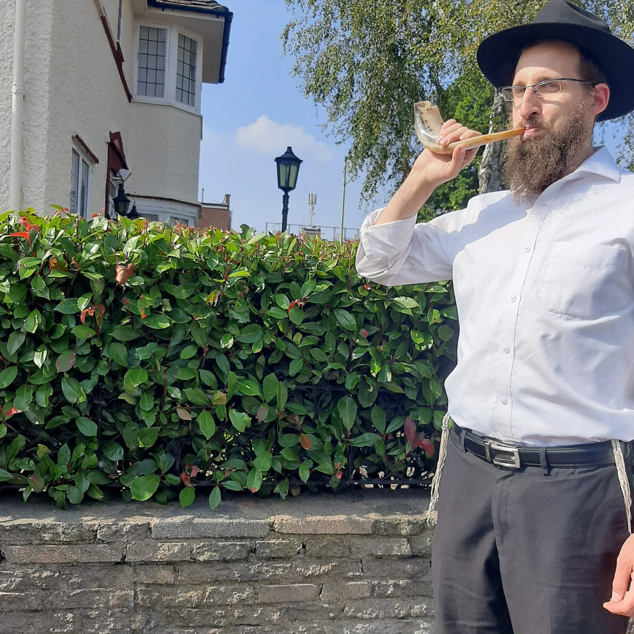 Rabbi blowing the shofar for the High Holidays at Chabad of Finchley