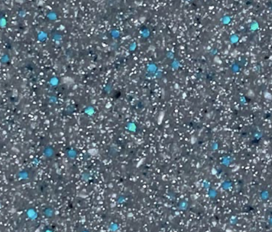 Close-up of a speckled surface with blue, white, and black particles on a grey background.