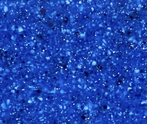 Close-up of blue glittery surface with sparkling particles