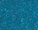 Close-up of a blue textured surface with small black and white specks.