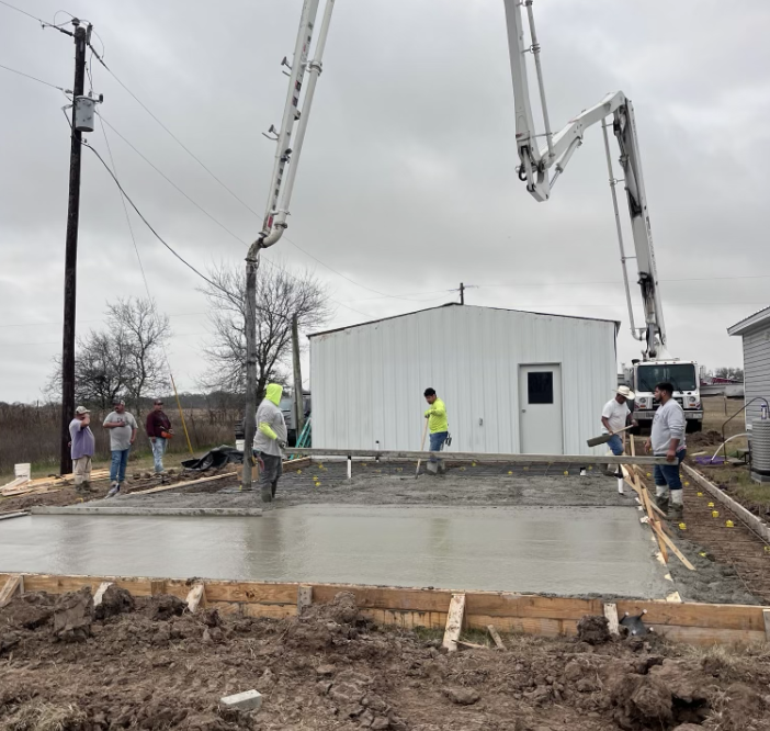 Laying concrete on an outdoor space.