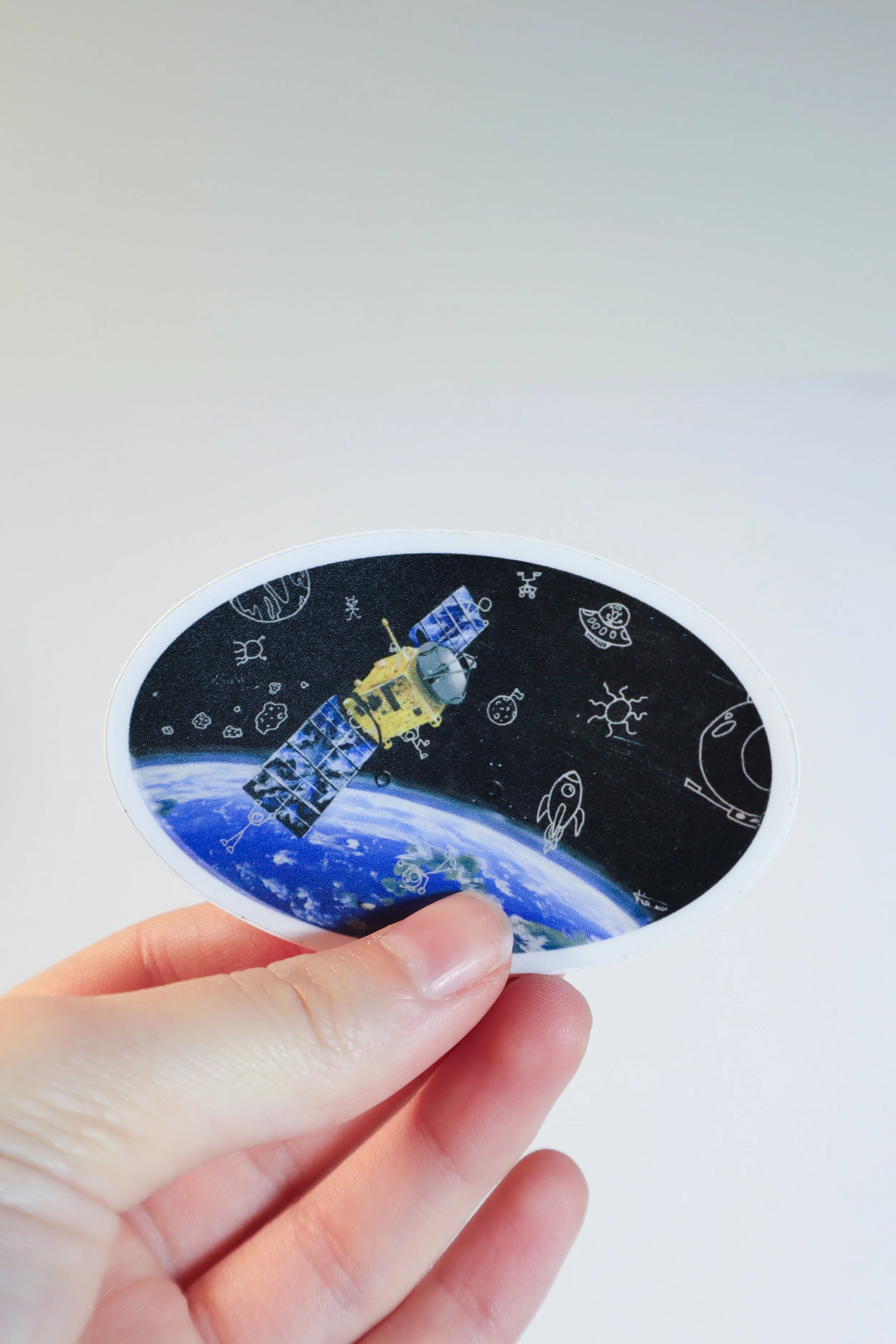 Satellite Orbiting Earth with Doodles Sticker