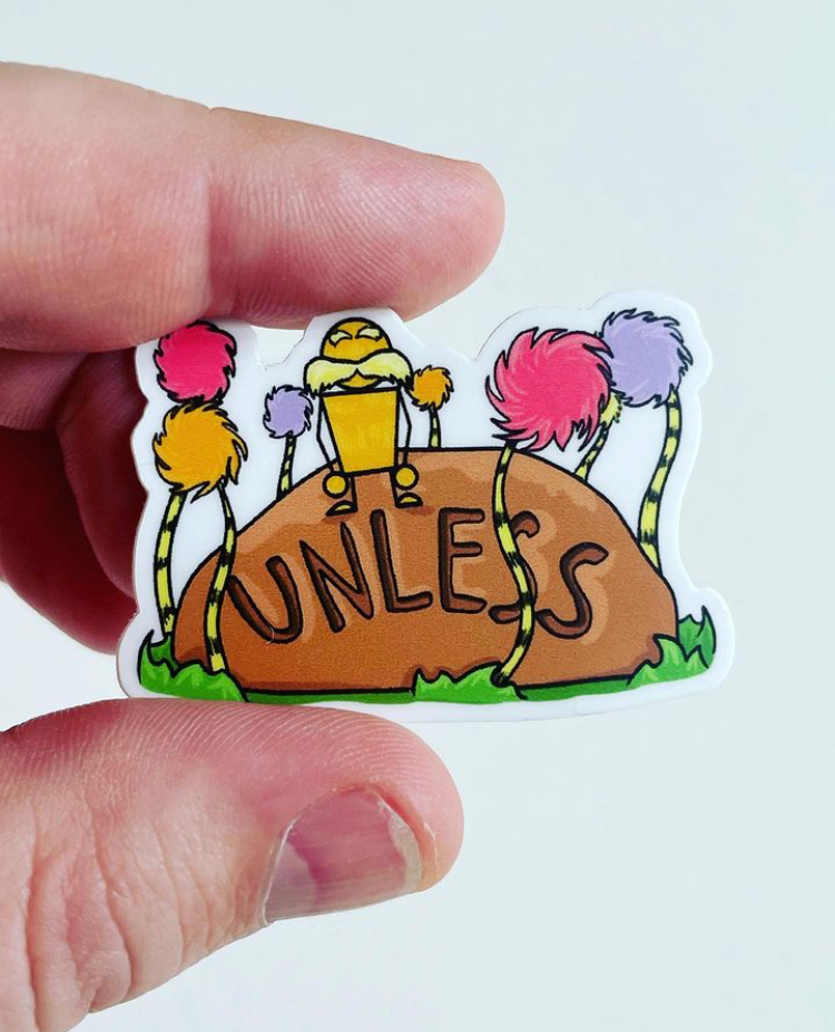 Colorful sticker featuring the word "UNLESS" on a large brown rock, surrounded by vibrant pink, orange, and purple tufted plants, with a yellow and orange character sitting on top.