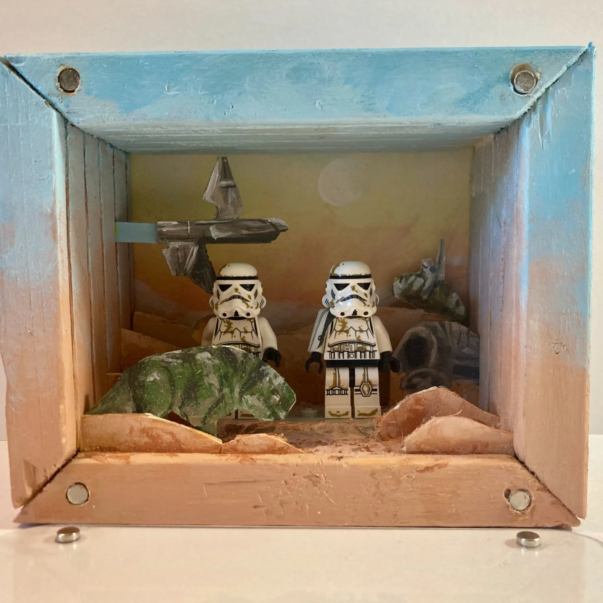 Star Wars-themed diorama with two LEGO stormtroopers, spaceship, rocks, and landscape background