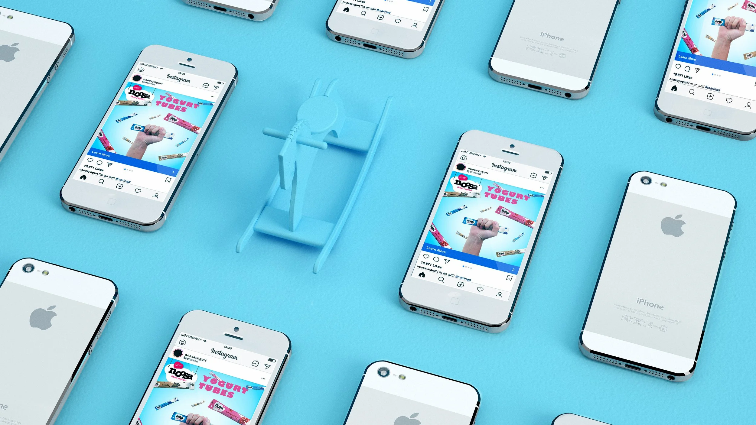 Multiple white iPhone models with screens showing Instagram posts, arranged on a blue surface with a small blue sled in the center.