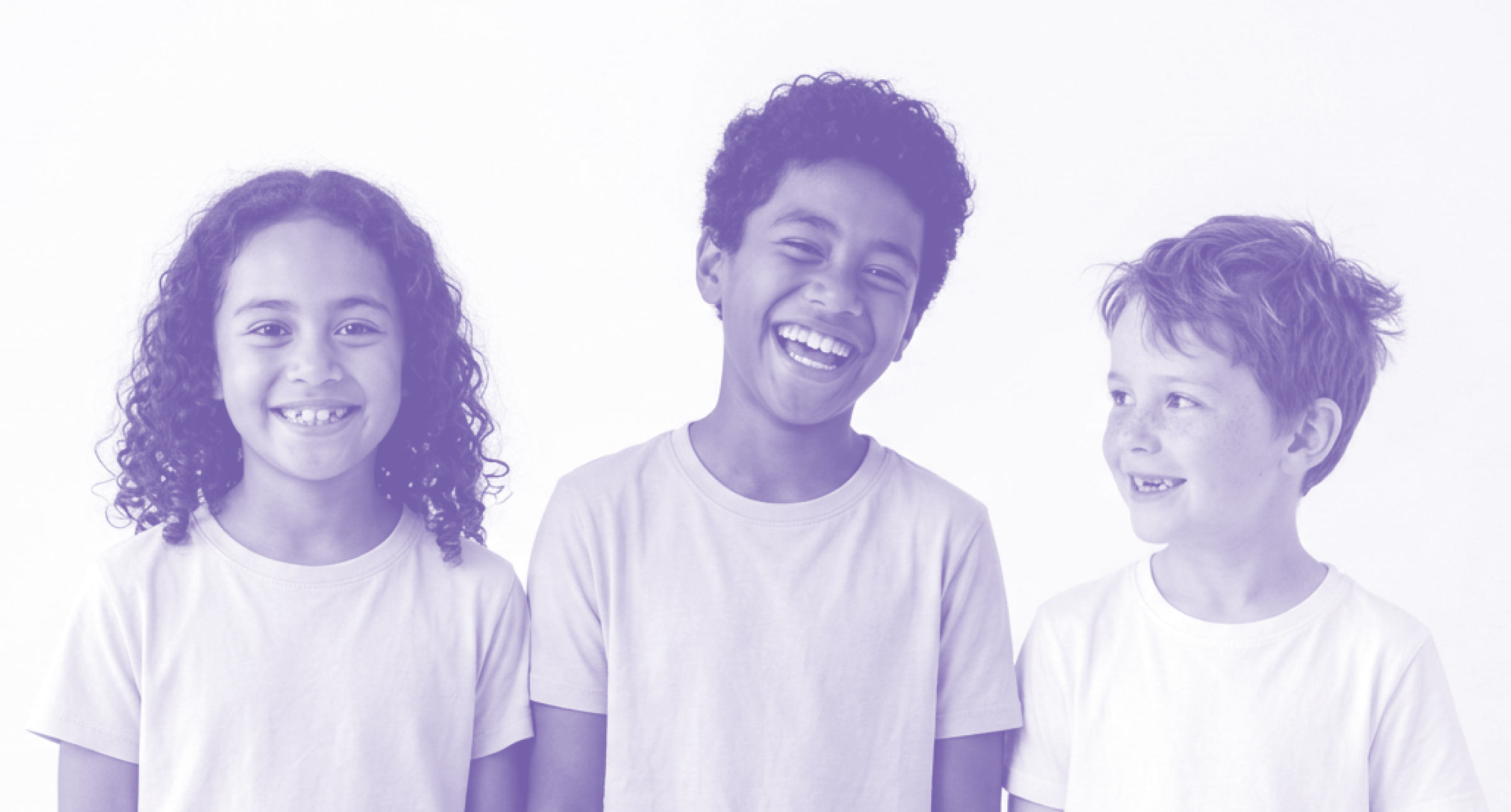 Three children smiling, standing side by side, wearing white t-shirts, against a plain white background.