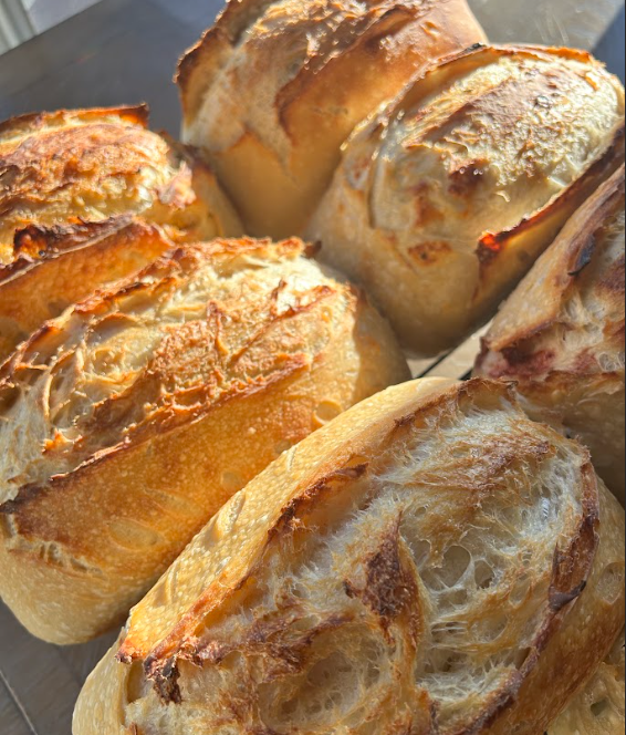 Close-up of several pieces of toasted bread with a golden-brown crust and soft, airy interior.