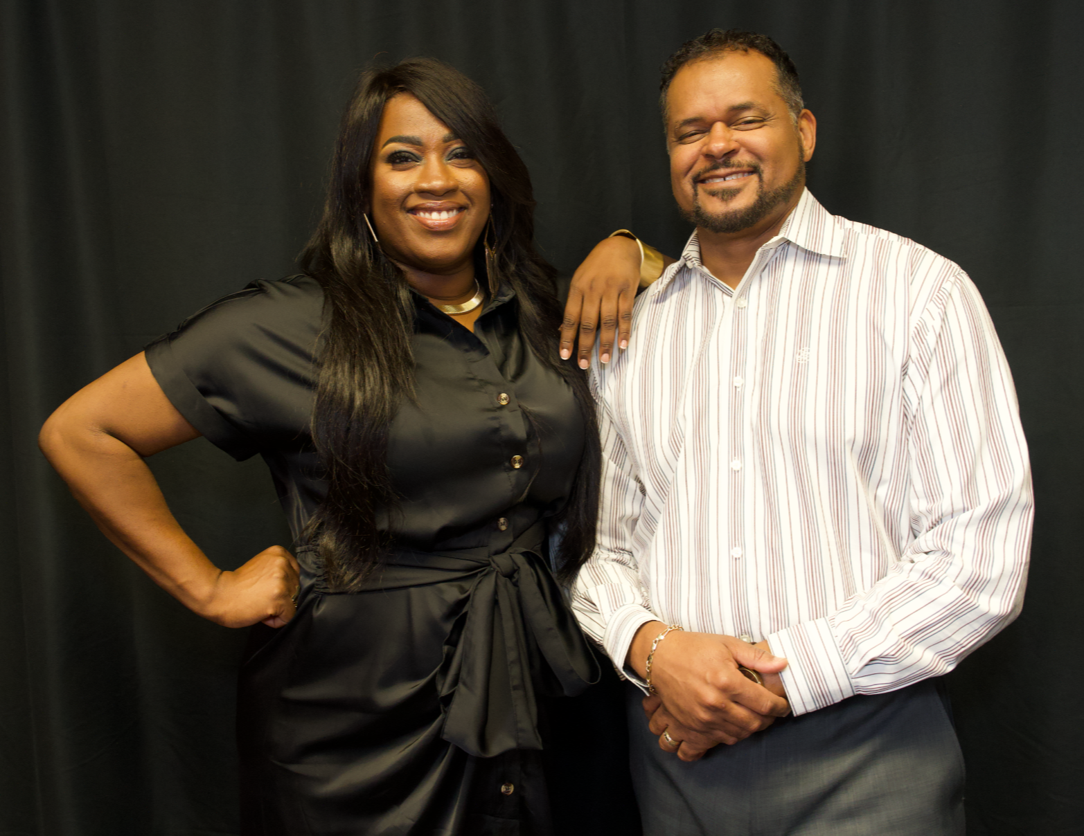 Milton Quinn and Jacquelyn Clayborn, co-founders of the Say Less Do More Foundation, standing together against a black backdrop.