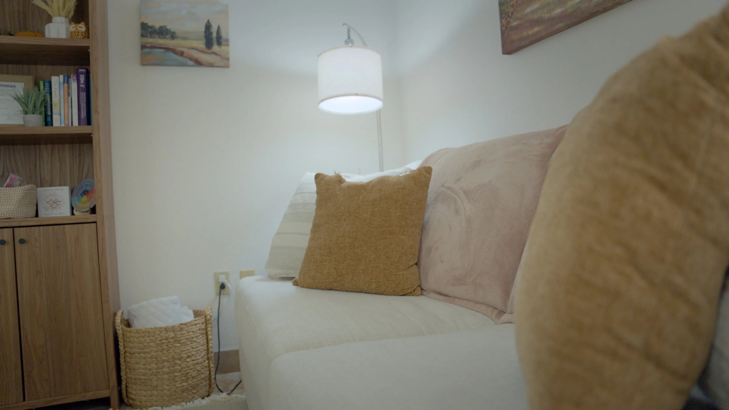 Calm therapy office with a soft couch and warm lamp at Elizabeth & Associates
