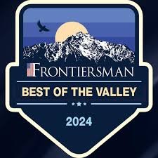 A logo for Frontiersman Best of the Valley 2024 featuring a mountain, a full moon, a bird, and stars.