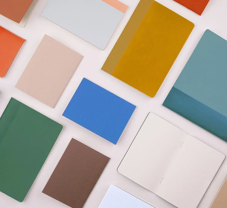 Various color swatches and sample cards laid out on a white surface.