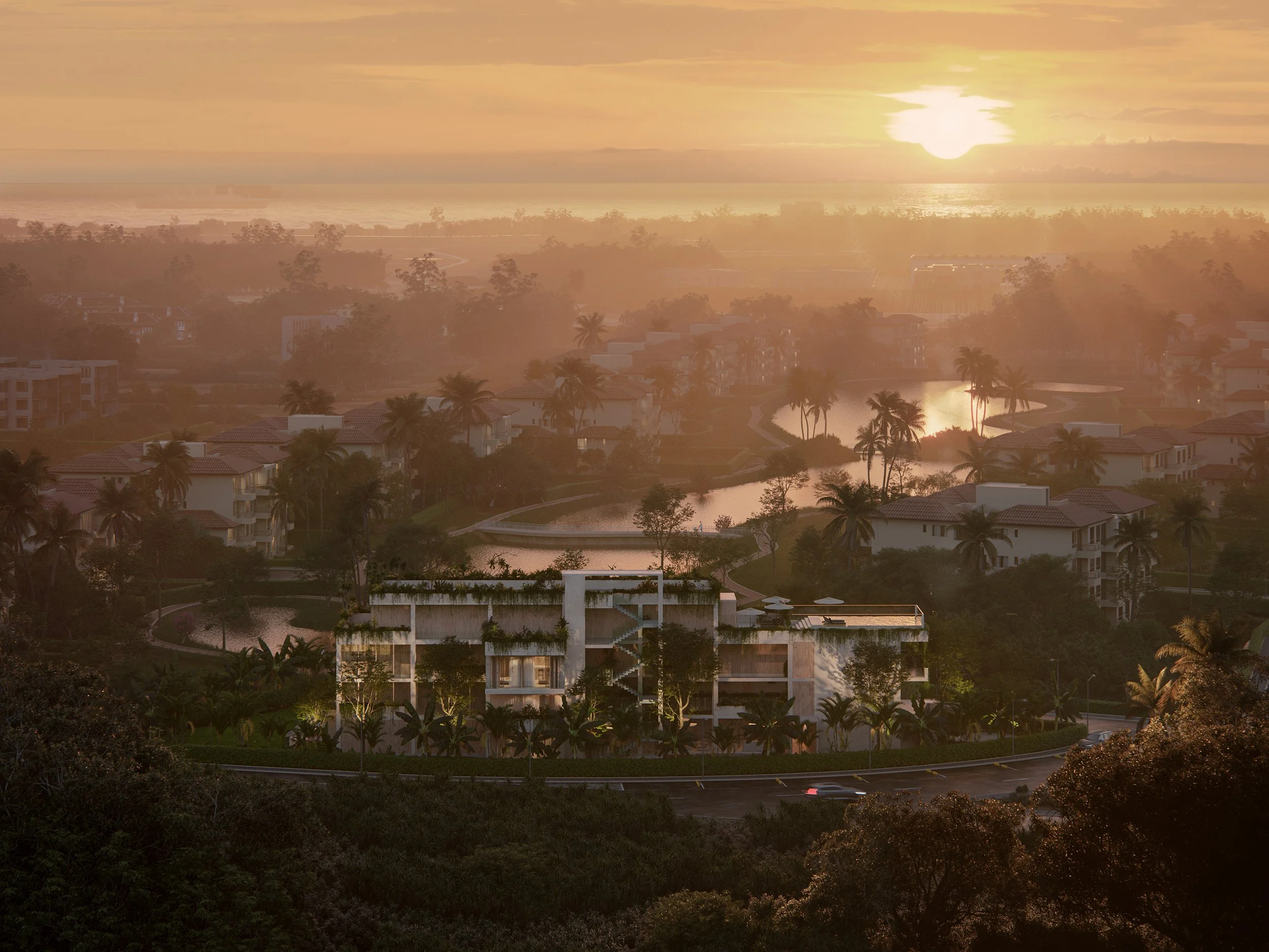 Sunset over a coastal residential area with buildings, palm trees, water, and a faint ship in the distance.