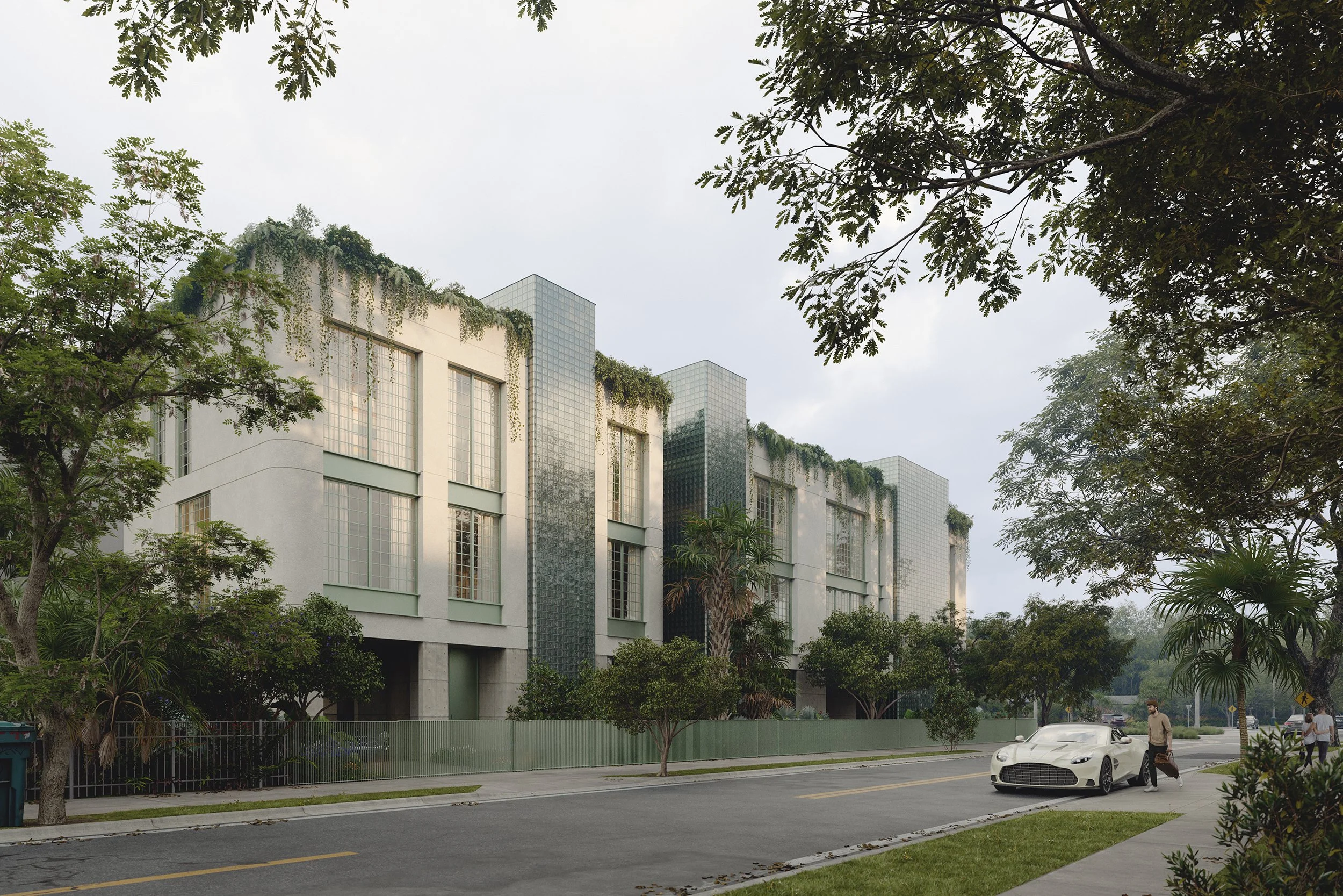 A modern building with large windows and greenery on its roof, framed by trees, with a street in the foreground where a white sports car and pedestrians are visible.