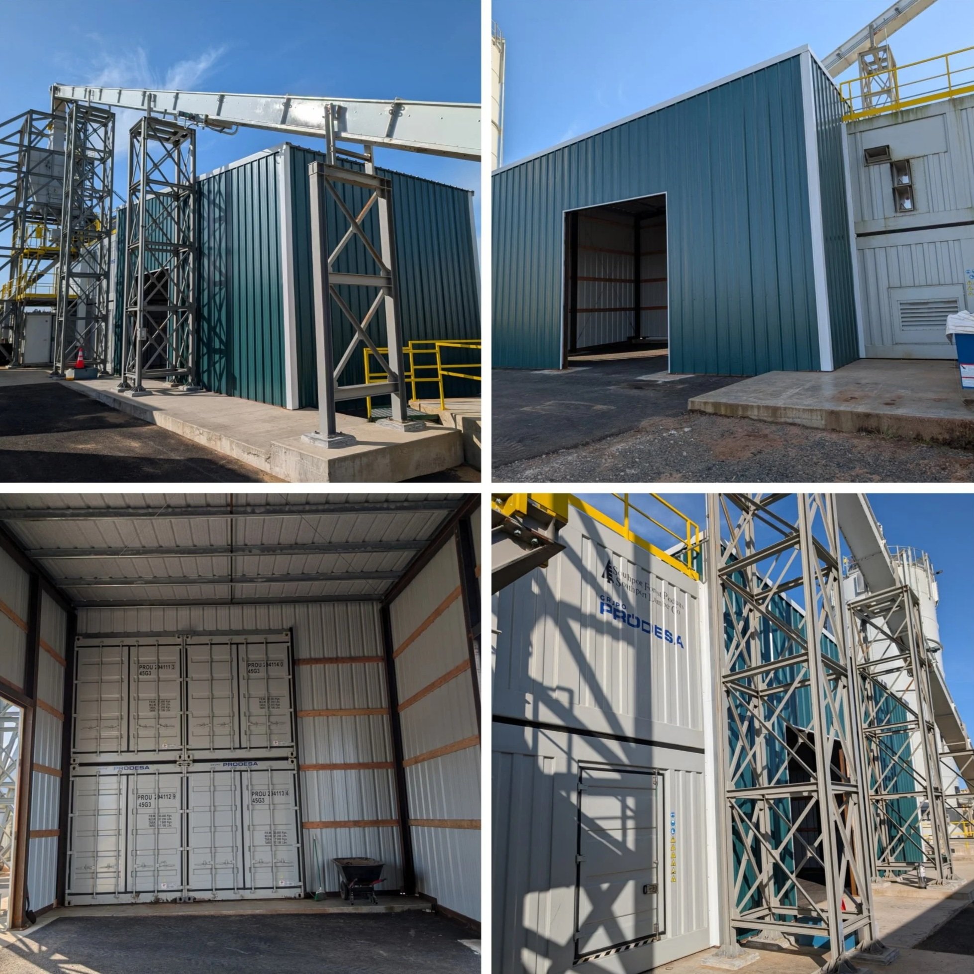 Industrial building with a large open garage door, metal siding, and scaffolding on the exterior. Clear blue sky overhead.