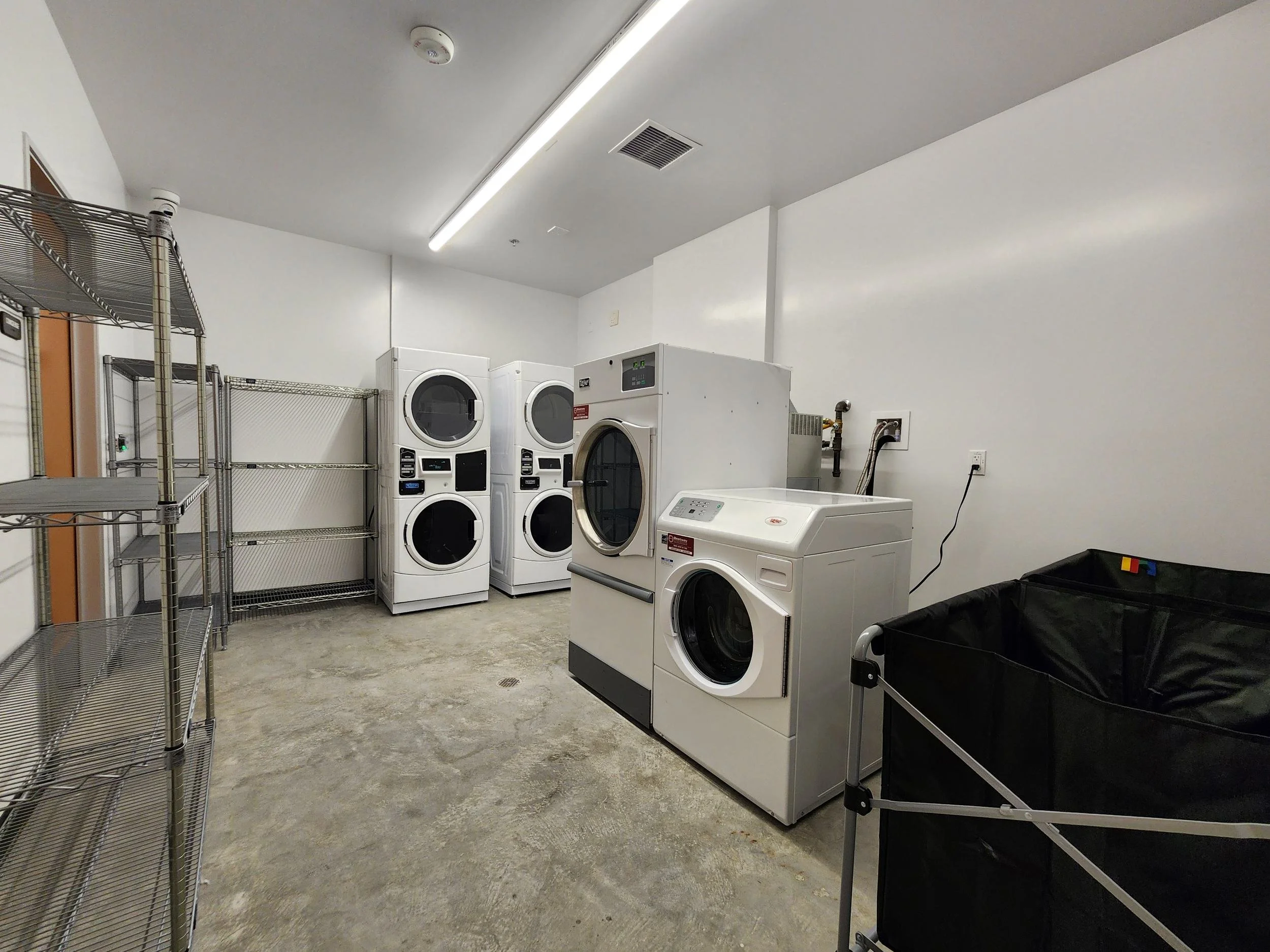 Commercial washers and dryers in the CCNC on-site laundry room