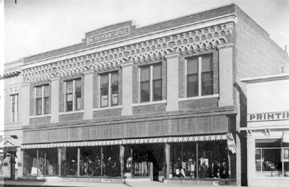 Archival black-and-white photo of the two-story New York Store building in downtown Sheridan.