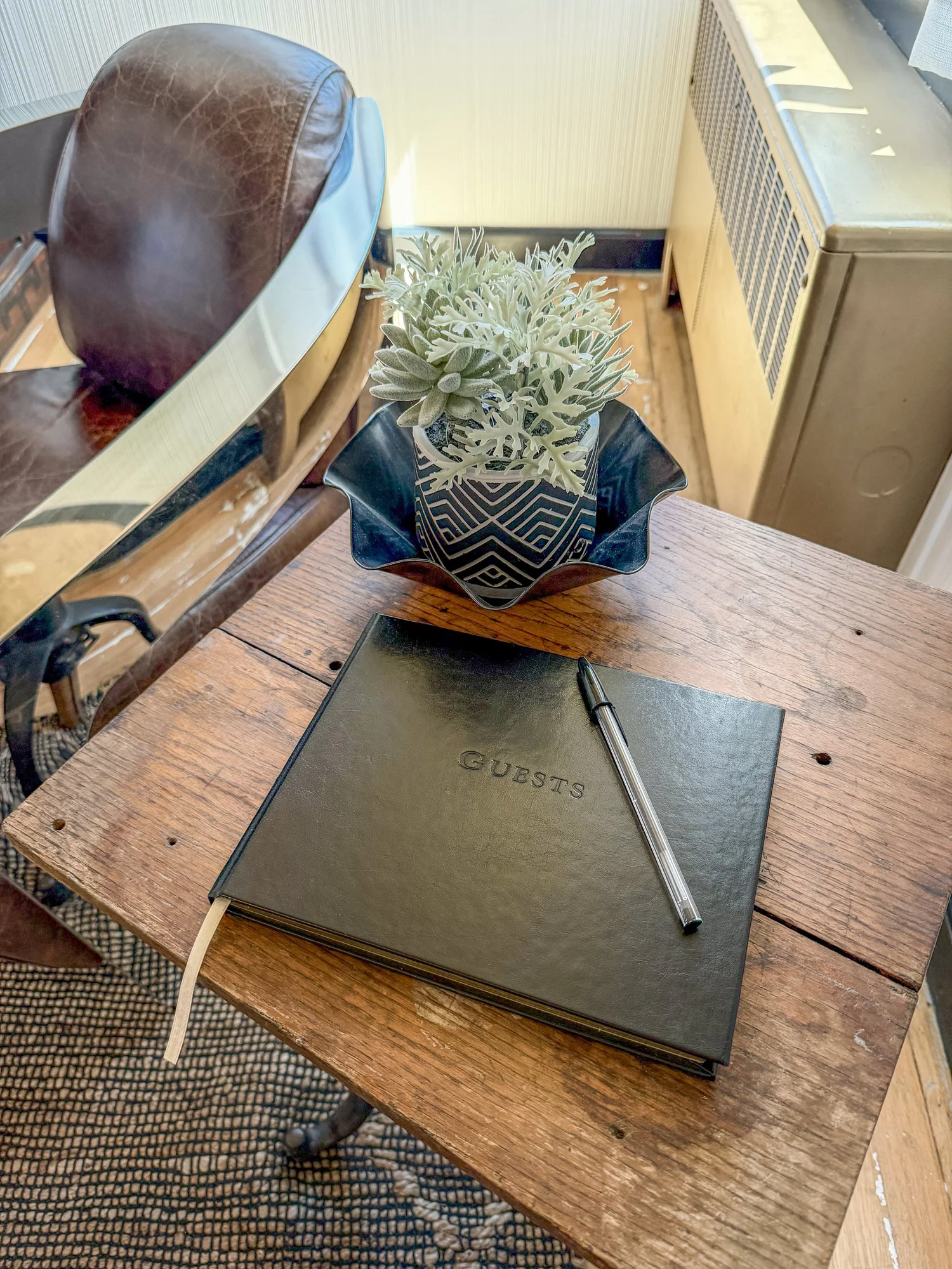 Leather guest book on a worn school desk at the Troubadour Suite, Sheridan Wyoming