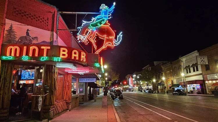 The Mint Bar neon sign and Main Street in Sheridan, Wyoming at night