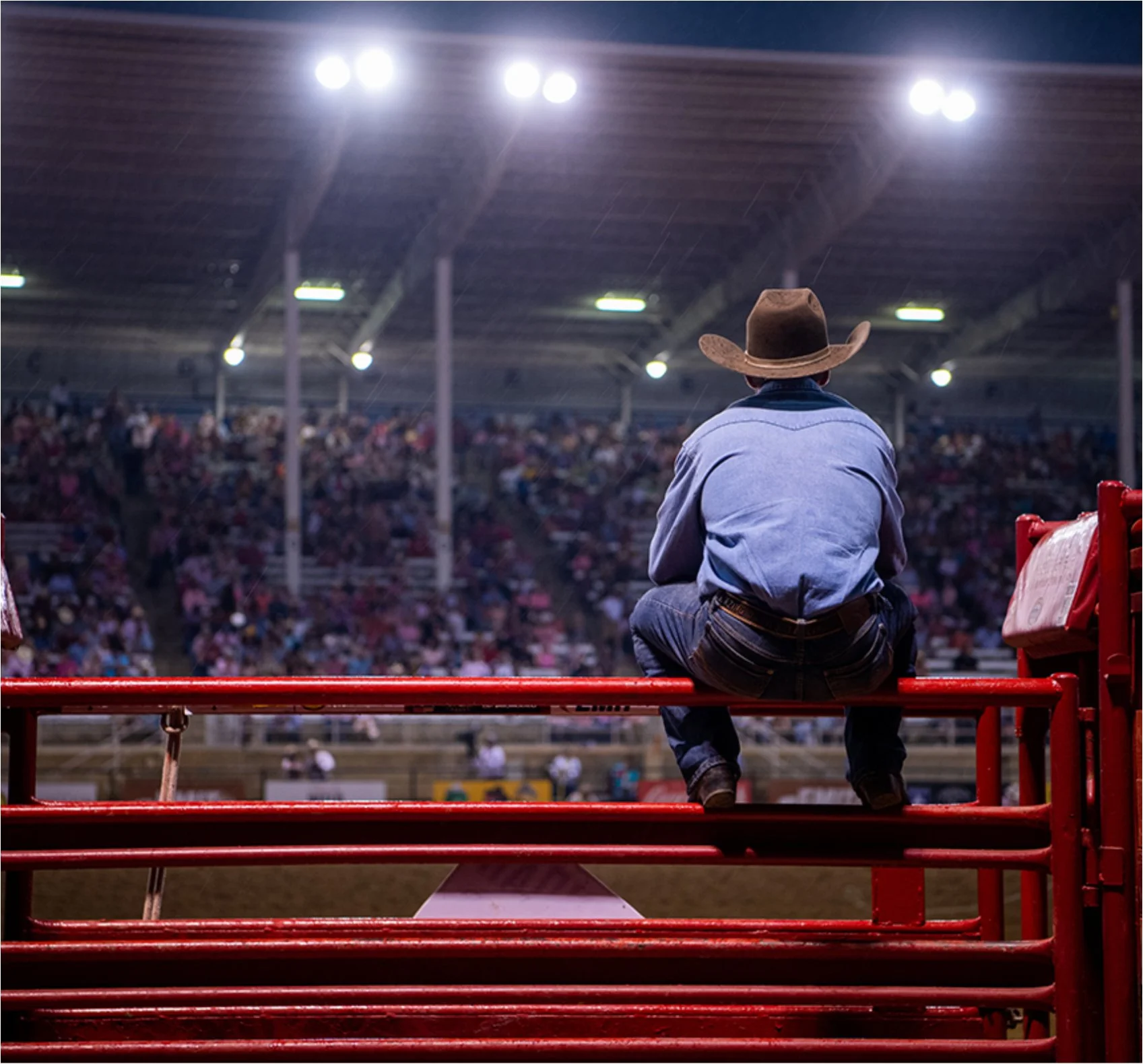 Cowboy at the Sheridan WYO Rodeo arena — 95th annual PRCA rodeo July 2026 Sheridan Wyoming