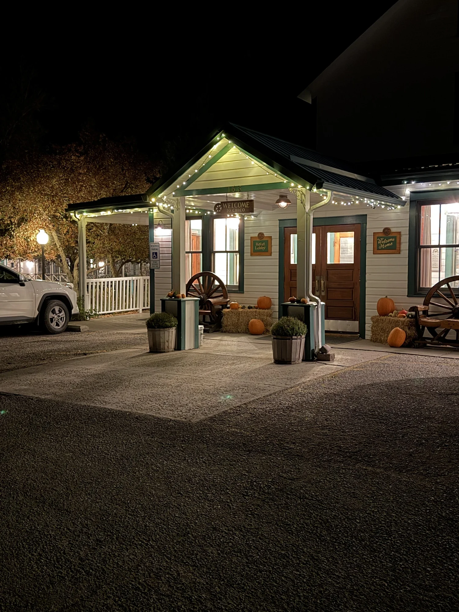 Chico Hot Springs entrance at night with string lights and pumpkins Paradise Valley Montana