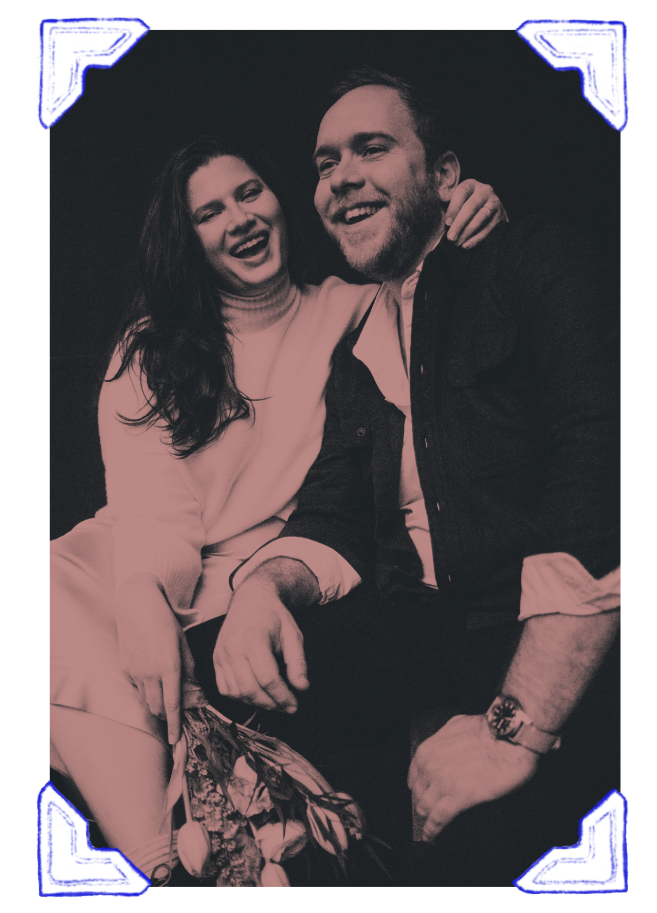 A black and white photo of a smiling man and woman sitting close together, with the woman laughing and the man with his arm around her shoulder.