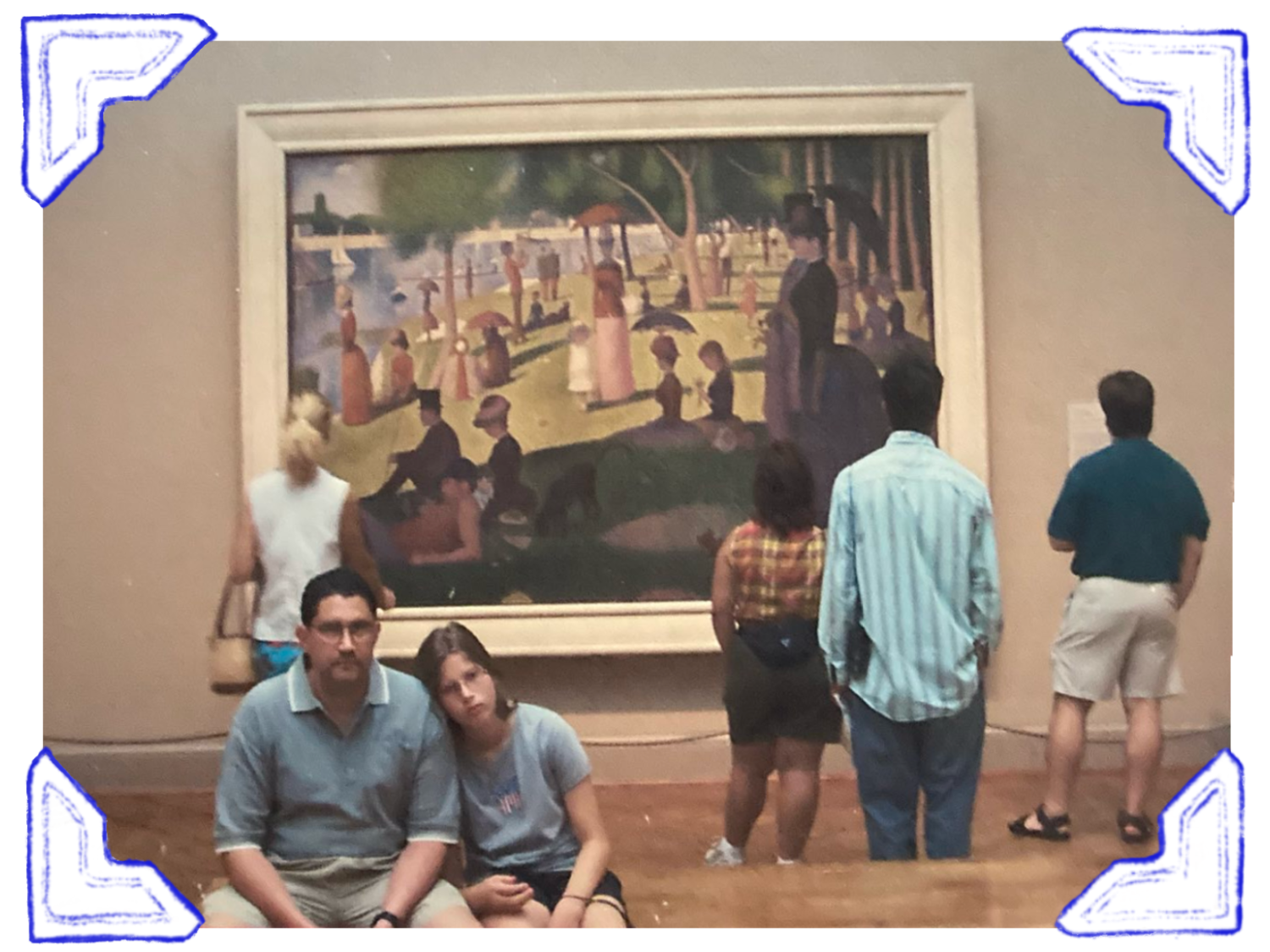 People viewing a large painting in an art gallery, with two individuals sitting on the floor in the foreground.