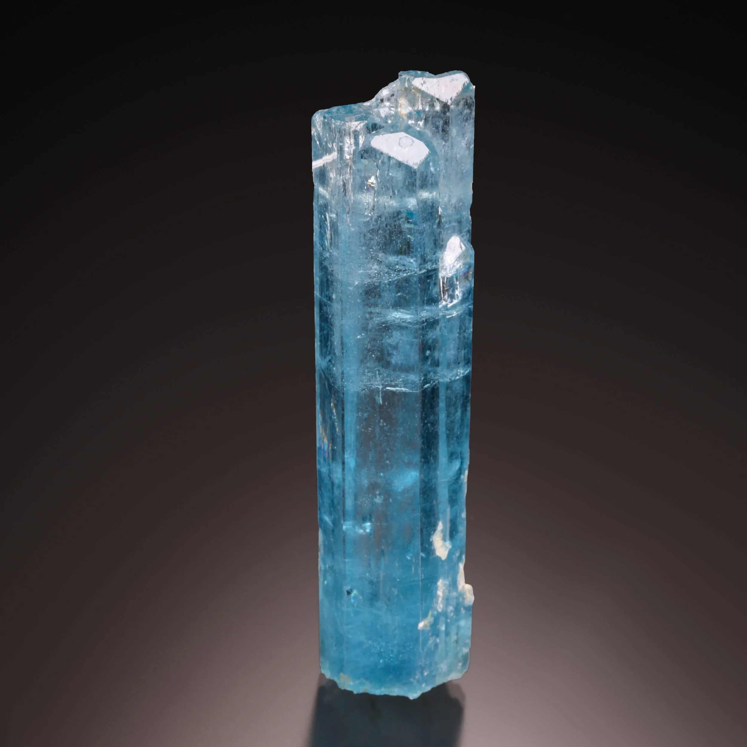 Blue aquamarine crystal on a dark background