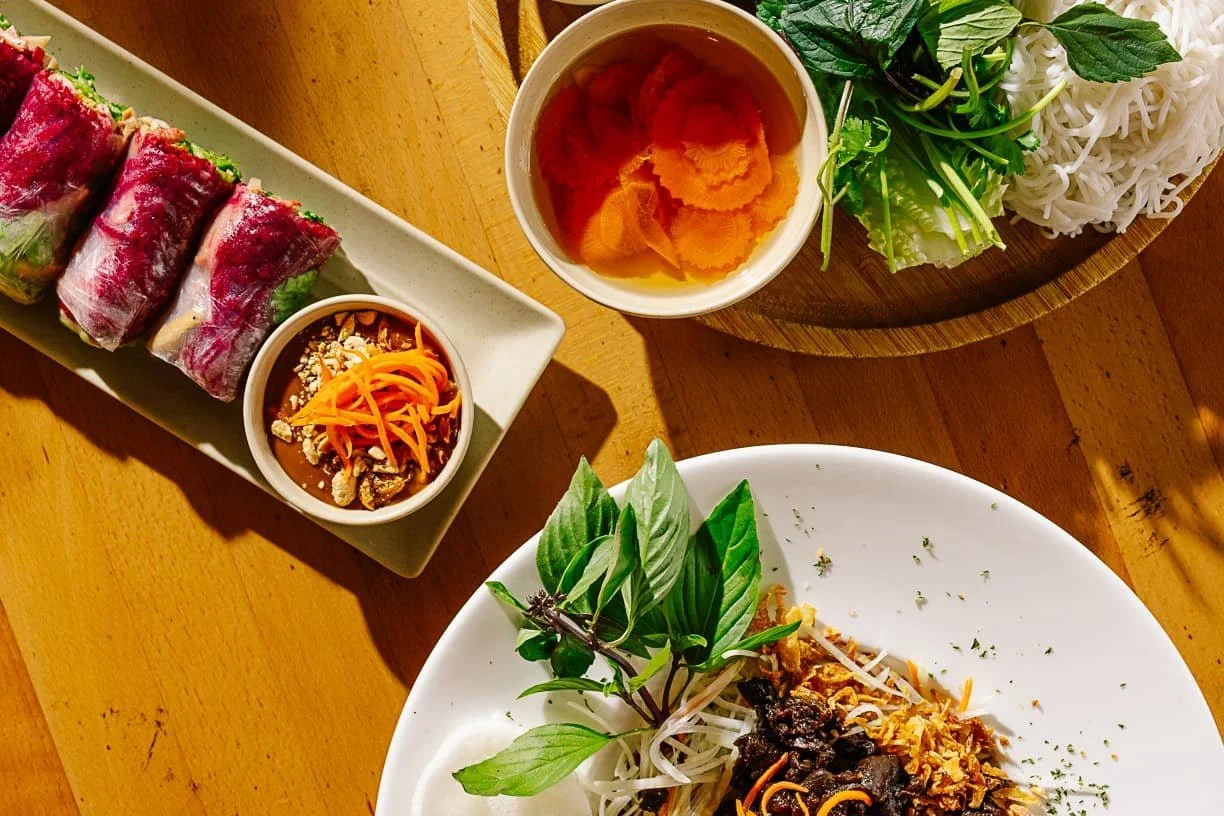 Various dishes from Ngon on a wooden table top