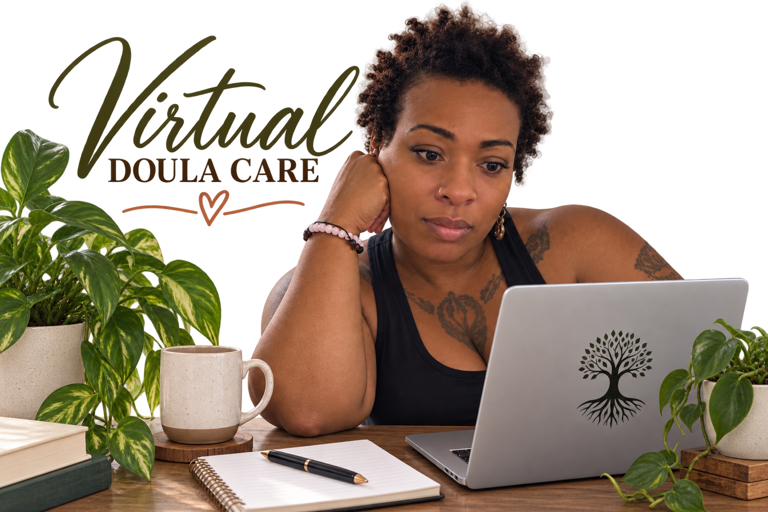 A woman with short curly hair and tattoos on her arms is sitting at a desk, looking at a laptop with a tree logo on the back. The desk has a notebook, pen, and a mug, with green plants on either side.