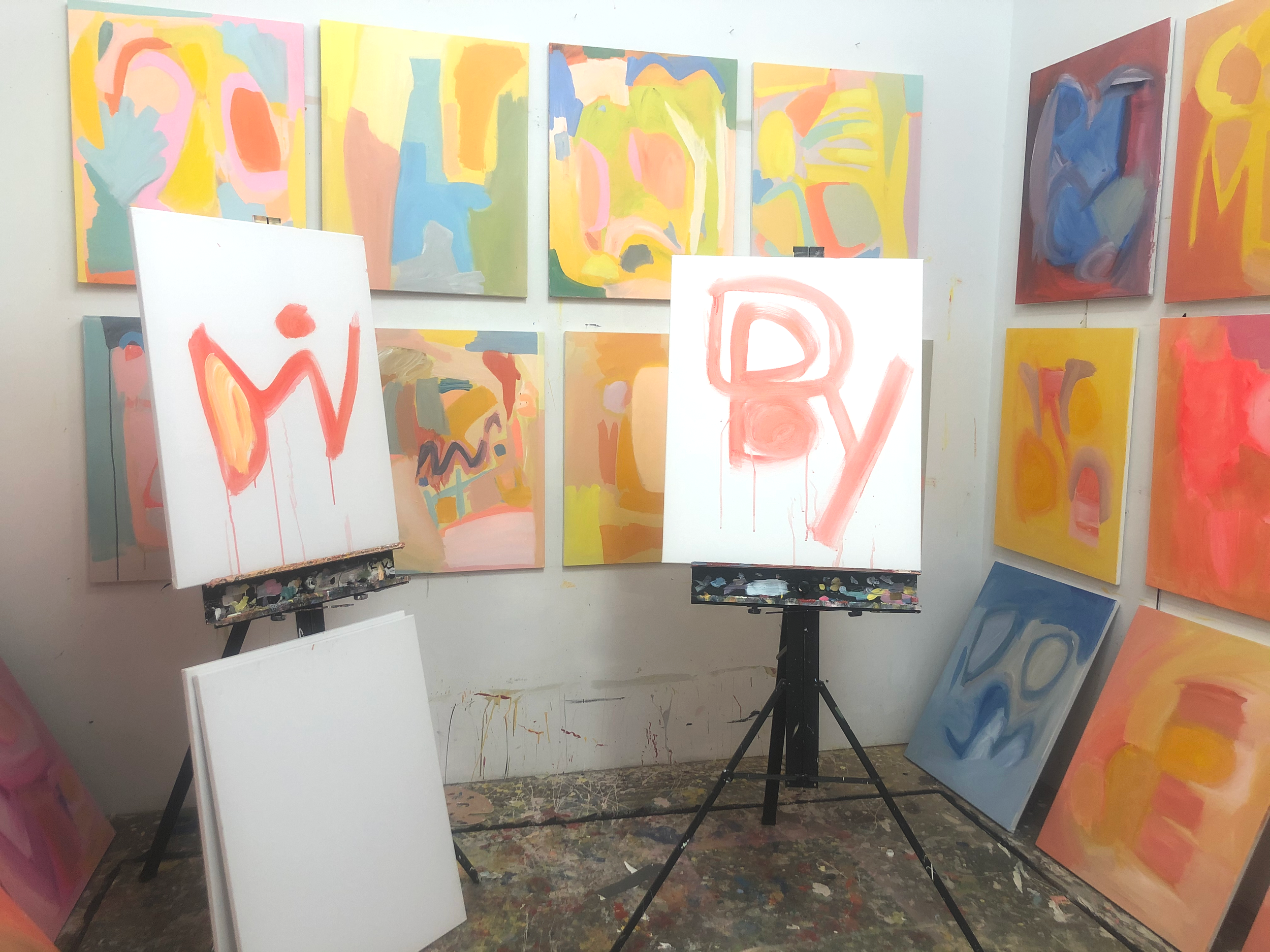 Oracle paintings in progress with the originating words loosely painted as a first step.