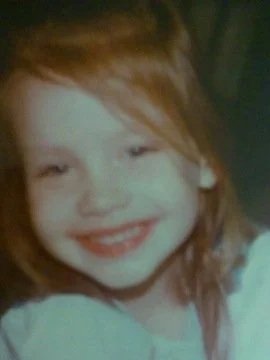 Smiling young girl with red hair and fair skin